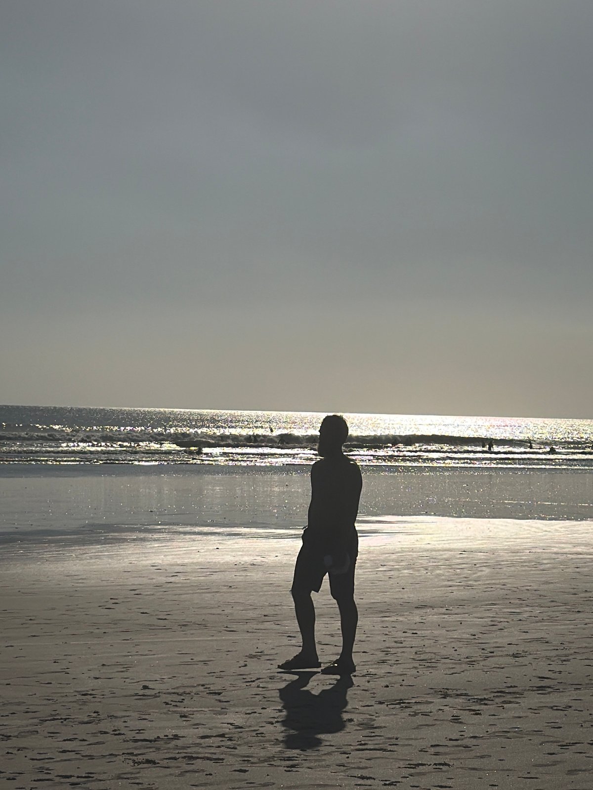 Morning scene at Kuta Beach, Bali — sand, surf, and street life
