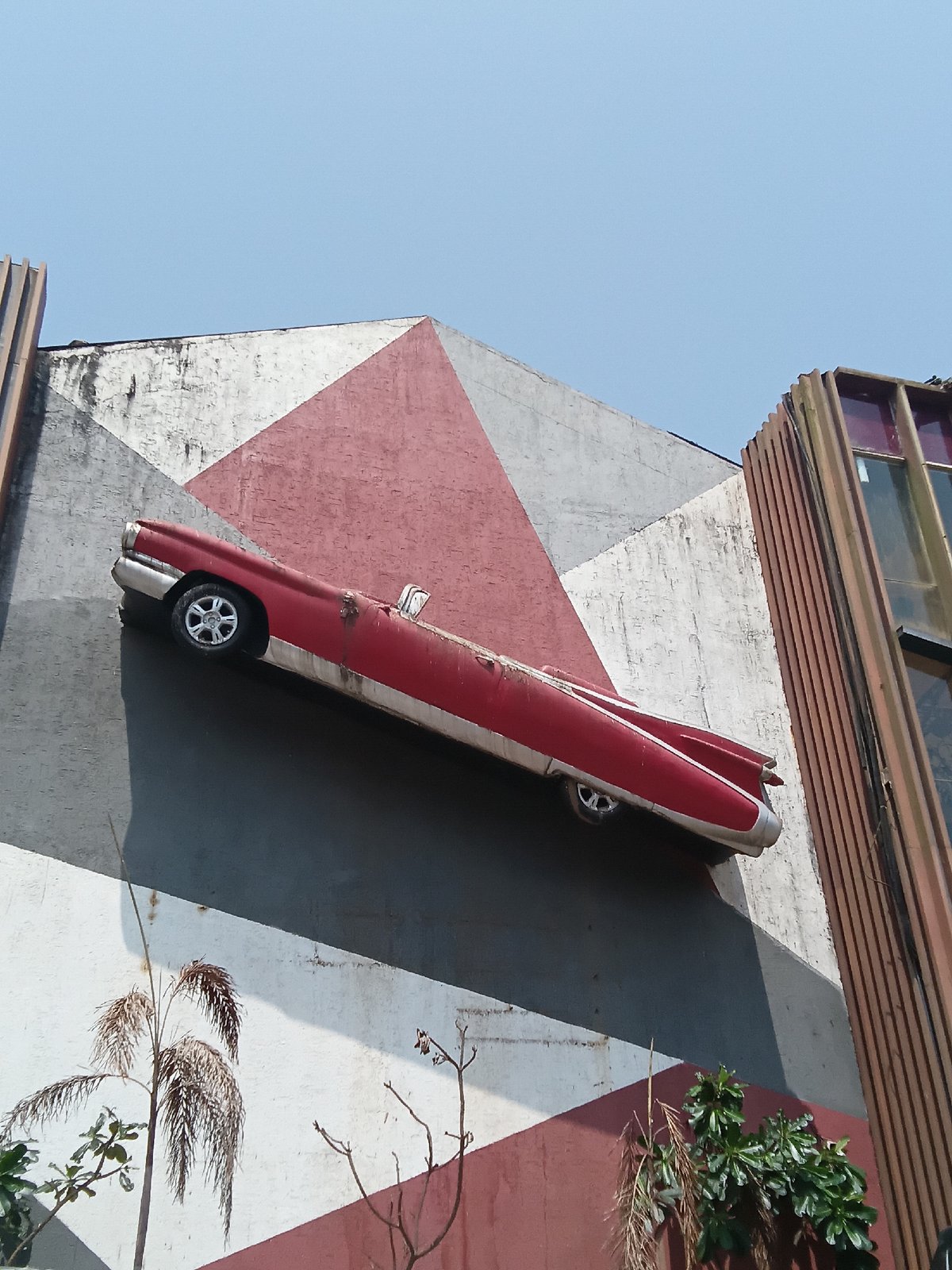 Vintage car body embedded in Vagator building facade