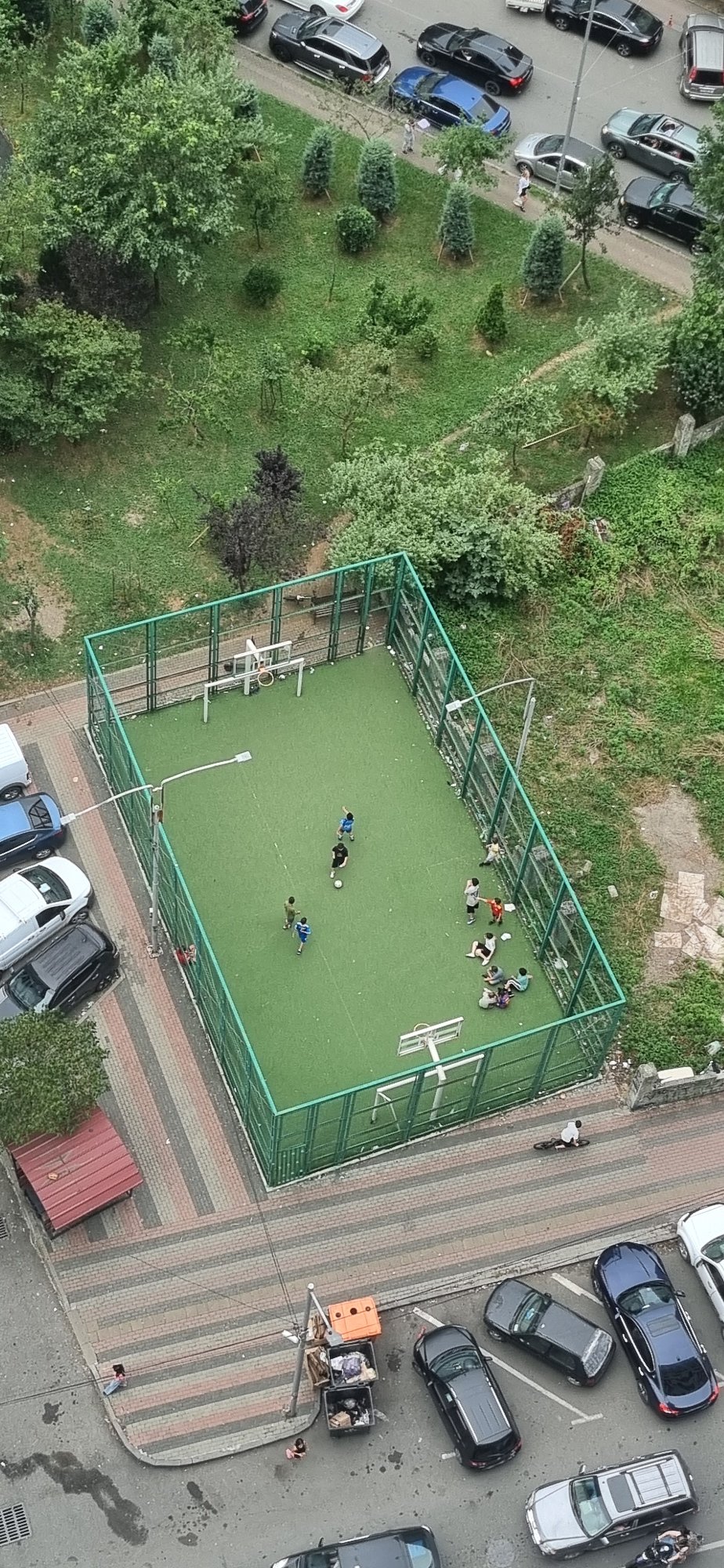 Midday aerial sweep of Batumi streets, intersections, and a soccer court