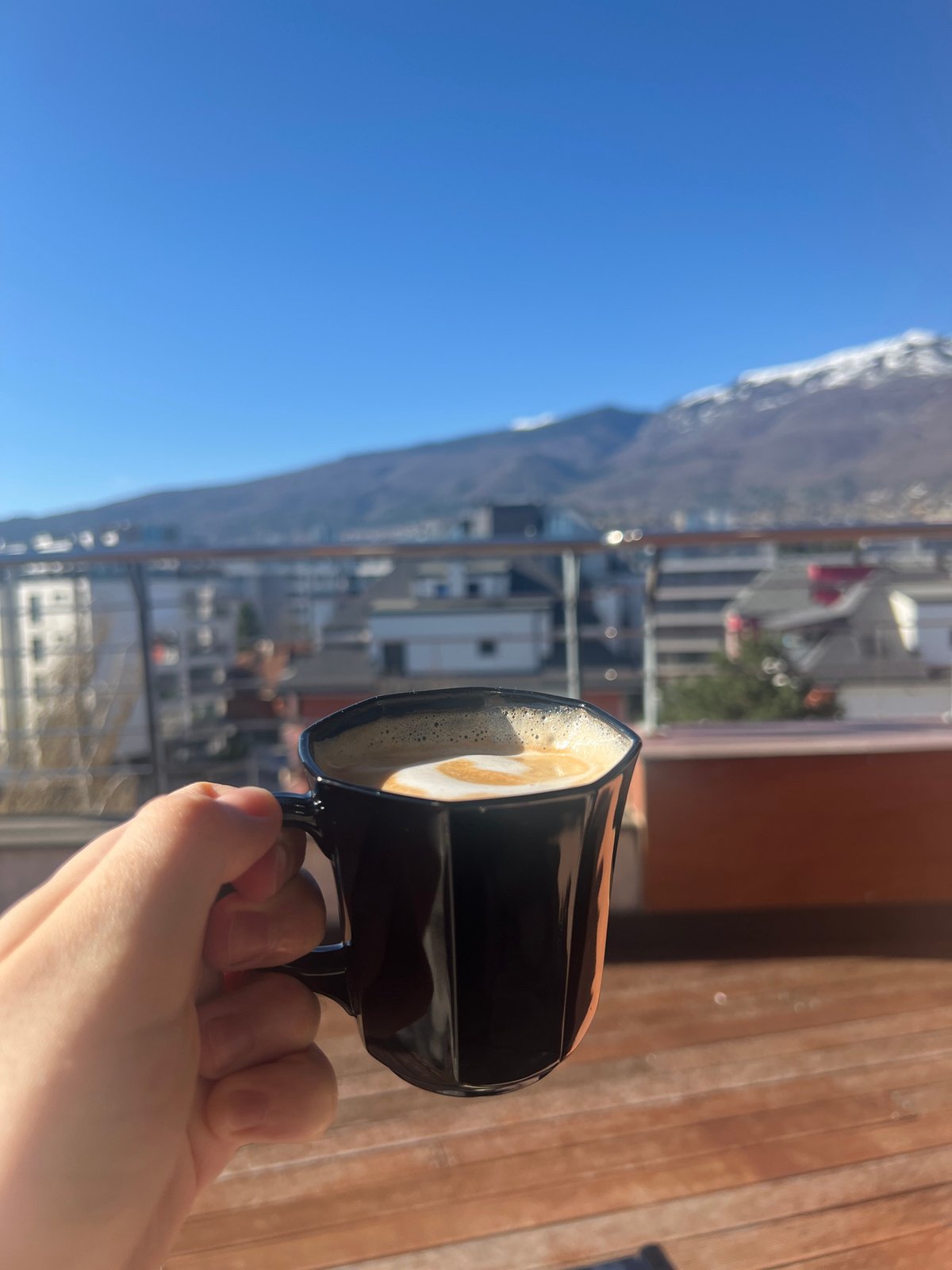 Morning coffee moment captured on Sofia balcony with mountain views
