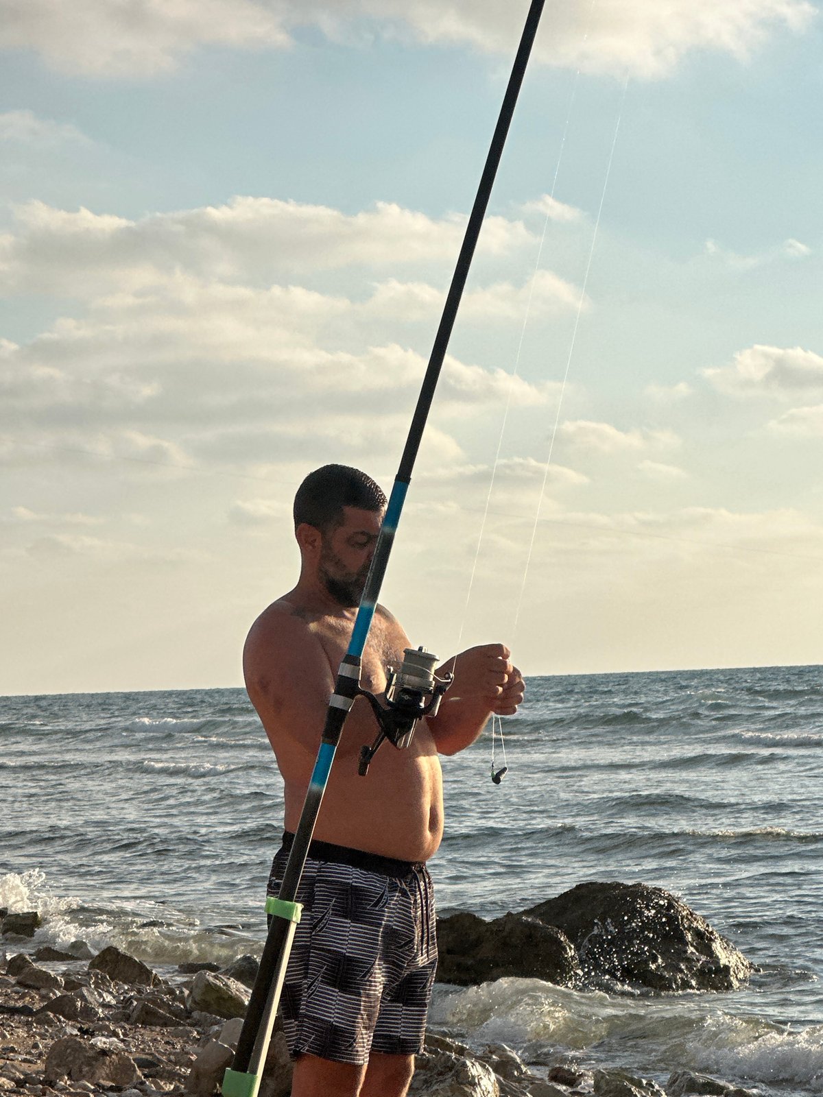 Lazy afternoon fishing and beers on Haifa's rocky shore