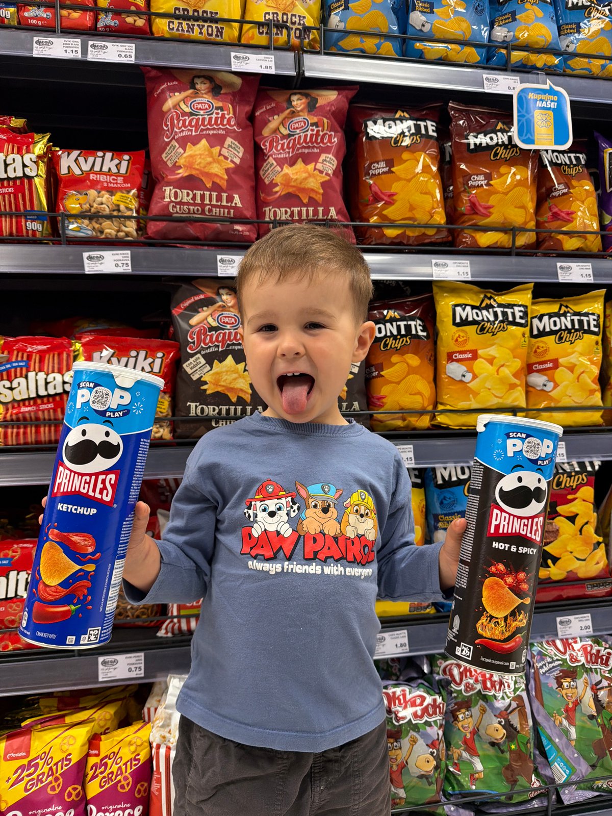 Boy shops playfully in Montenegro supermarket wearing Paw Patrol shirt