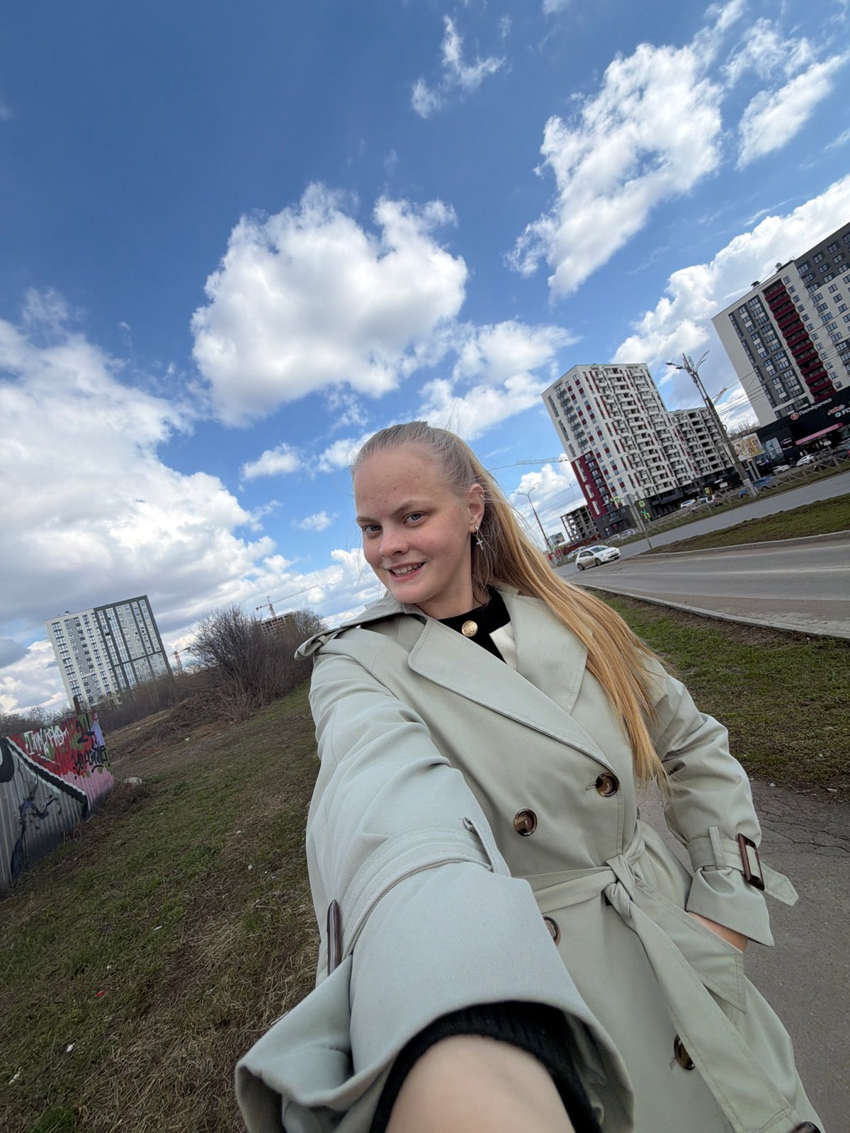 Woman in trench coat photographed in Izhevsk urban area