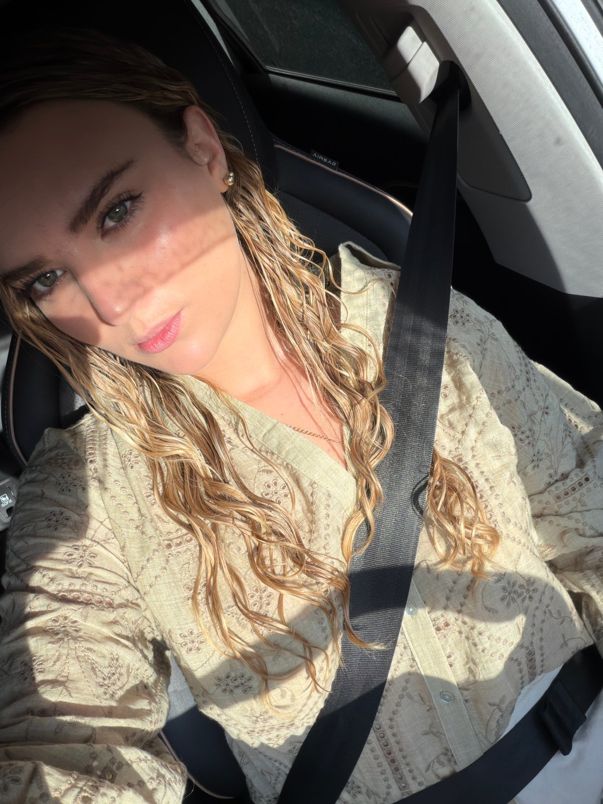 Woman observed seated in vehicle interior in Puebla