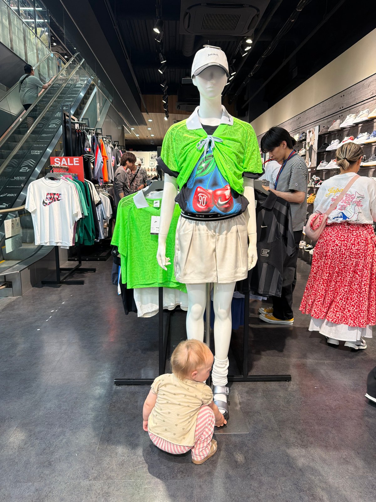 Weekend shoppers browse Kyoto arcade with children, pets, games