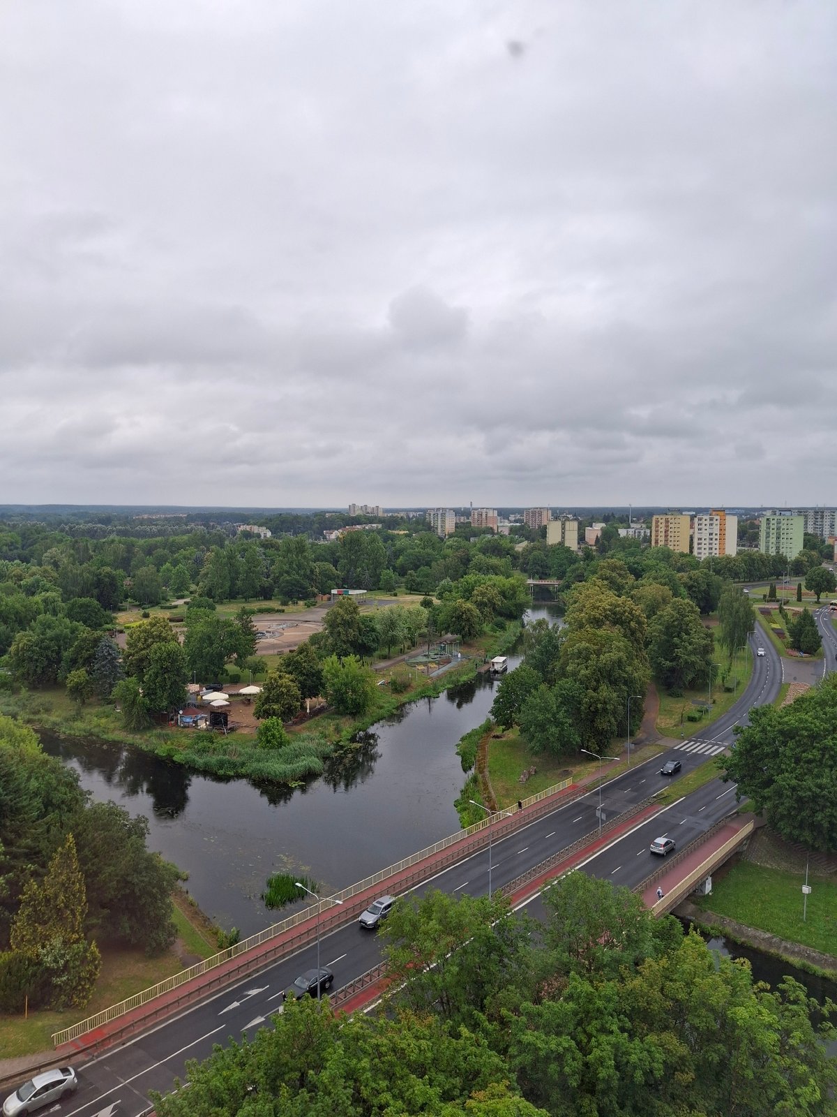 Aerial view of Piła's urban landscape, greenery, and waterway