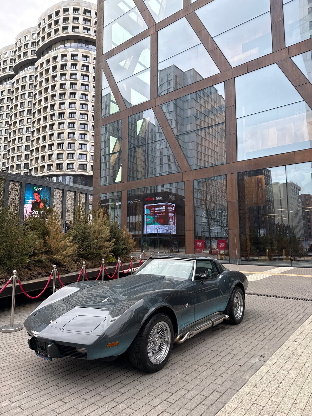 Moscow public square displays vintage car, Gothic sculpture installations