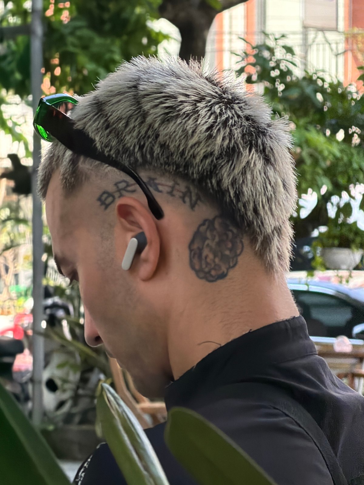 Morning scenes captured at Đà Nẵng cafe with tattooed patron