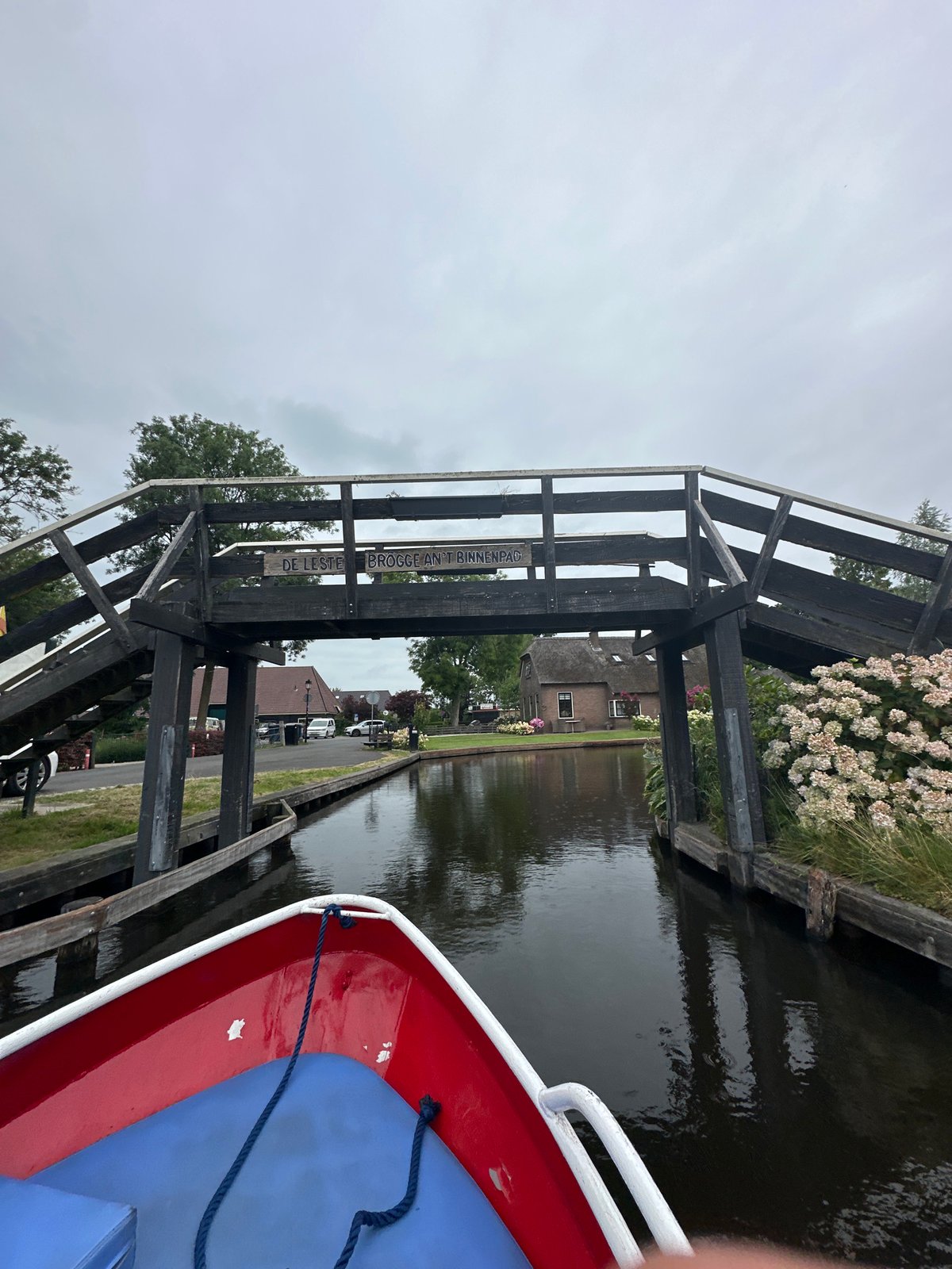 Boating through Giethoorn's canals on a grey summer morning