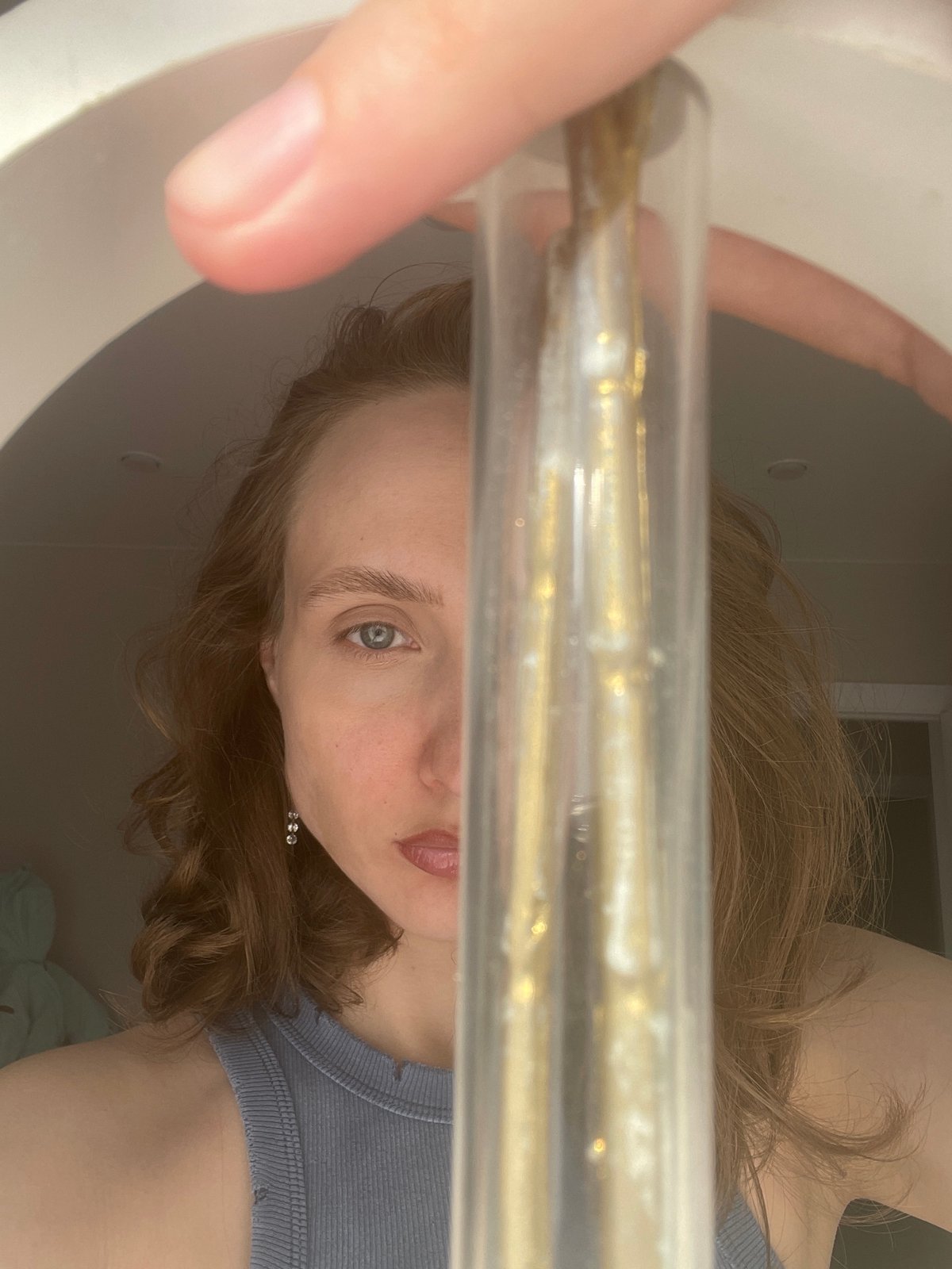 Woman Takes Selfies While Handling Golden Substance in Russian Home