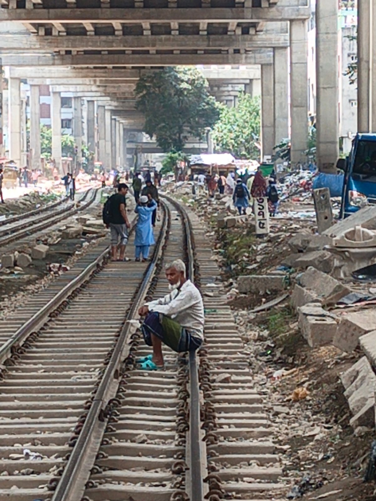 Daily life continues around Dhaka railway tracks, vendors active