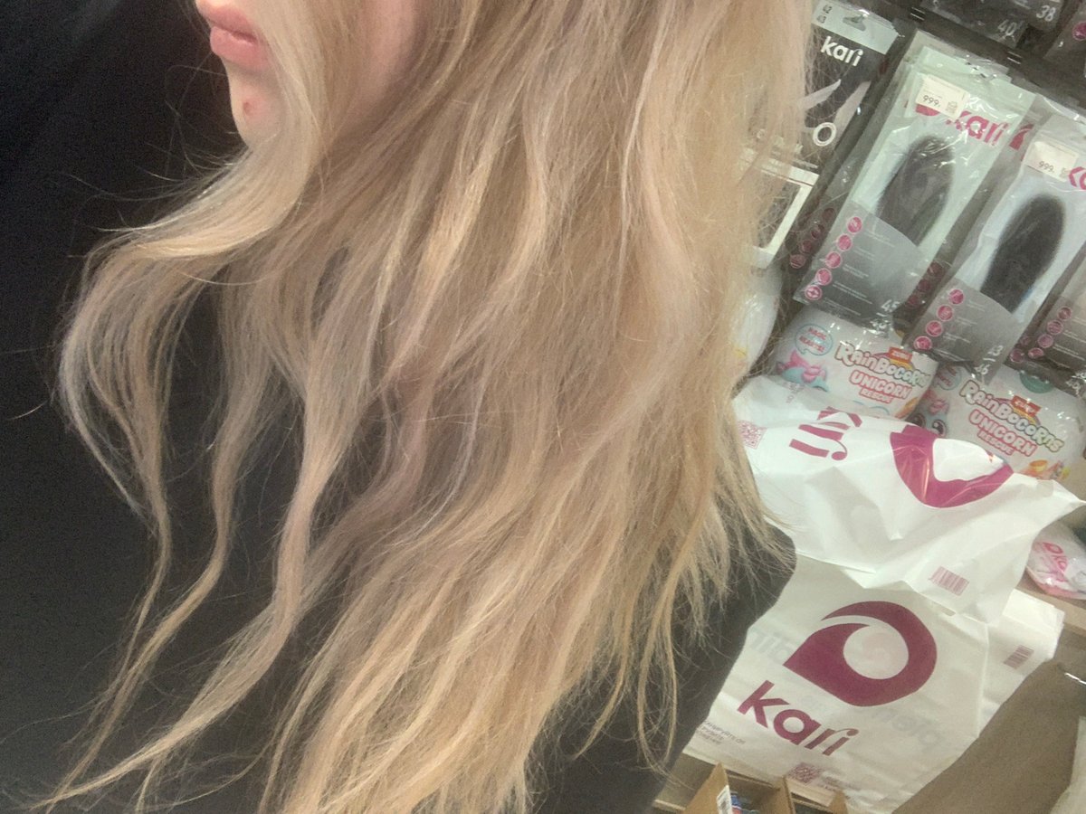 Blonde shopper films selfies while toy shopping in Petersburg