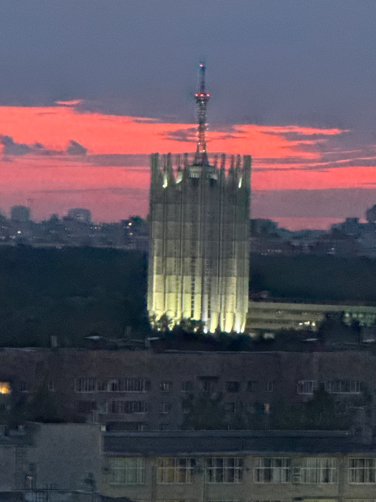 Twilight captures urban Sinyavino skyline with tower, residential buildings