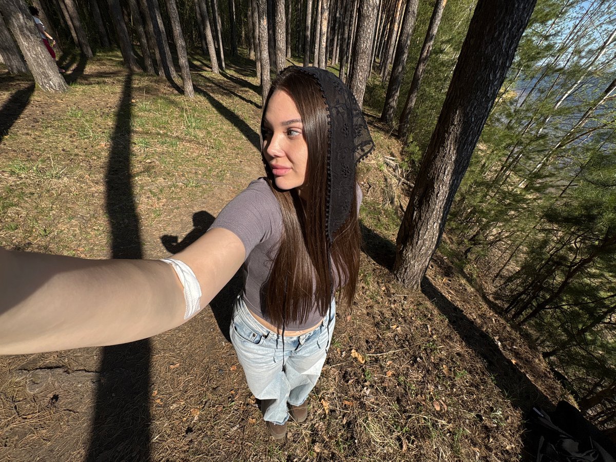 Woman Takes Early Morning Forest Selfies Near Water