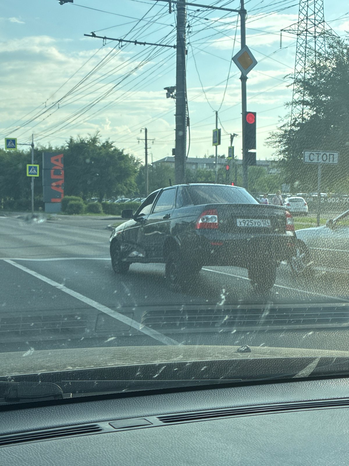 Black Lada at Russian intersection with traffic signals
