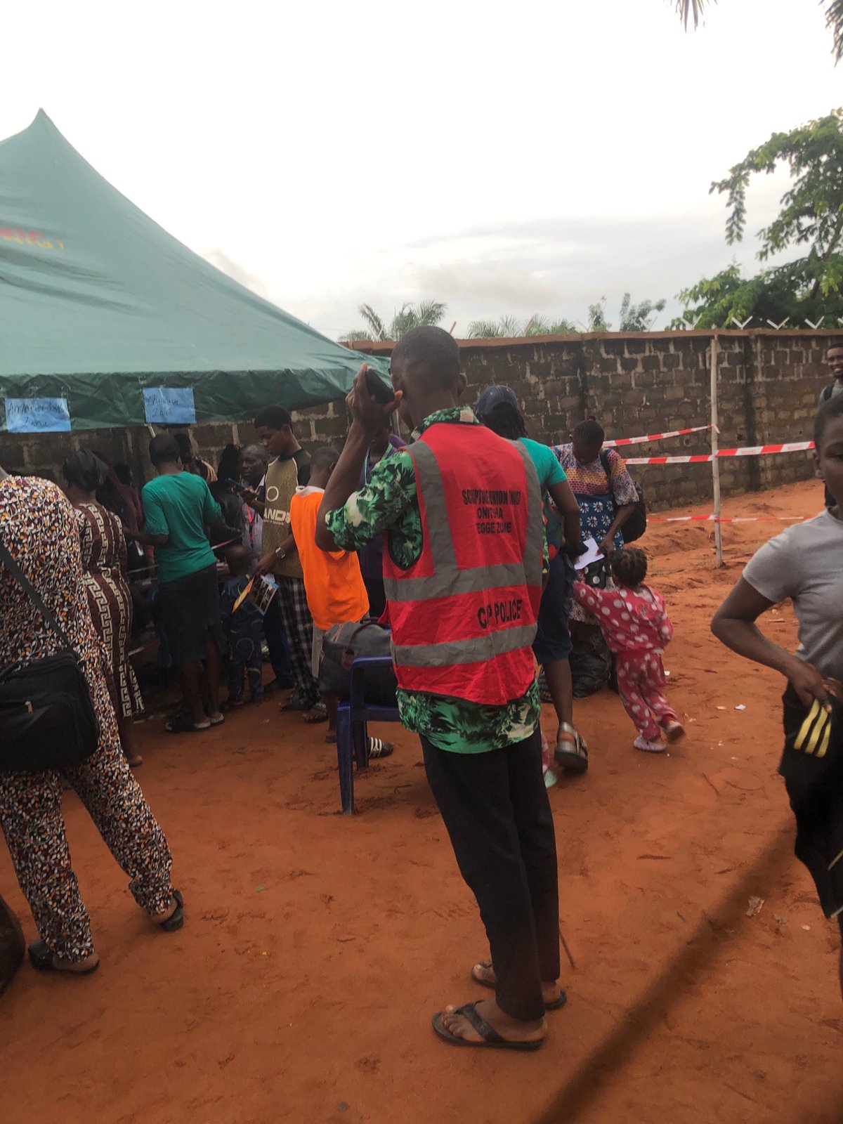 Community gathering under tent in Nteje, Nigeria