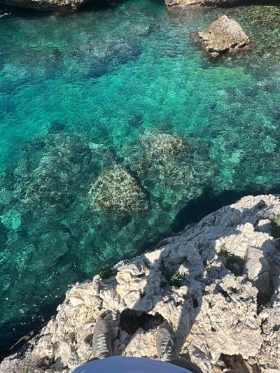 Visitor documents pristine rocky coastline in Nardò, Italy