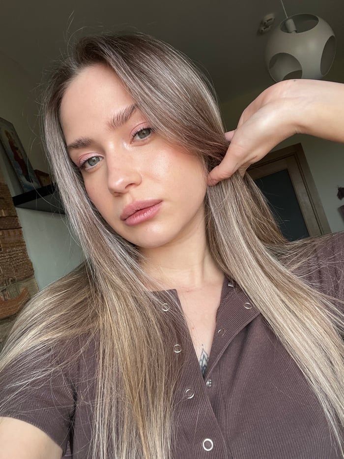 Woman photographed during makeup routine in Saint Petersburg apartment
