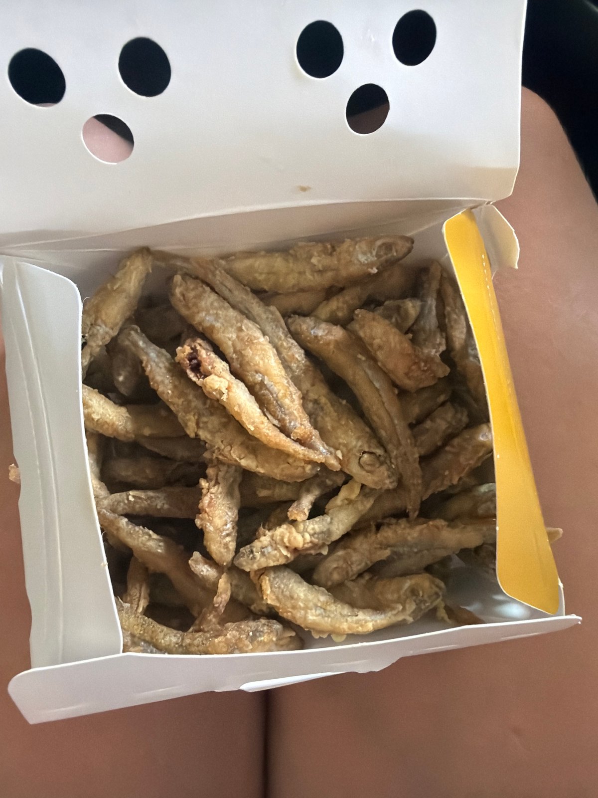 Fresh fried small fish served in a paper box, Strovolos