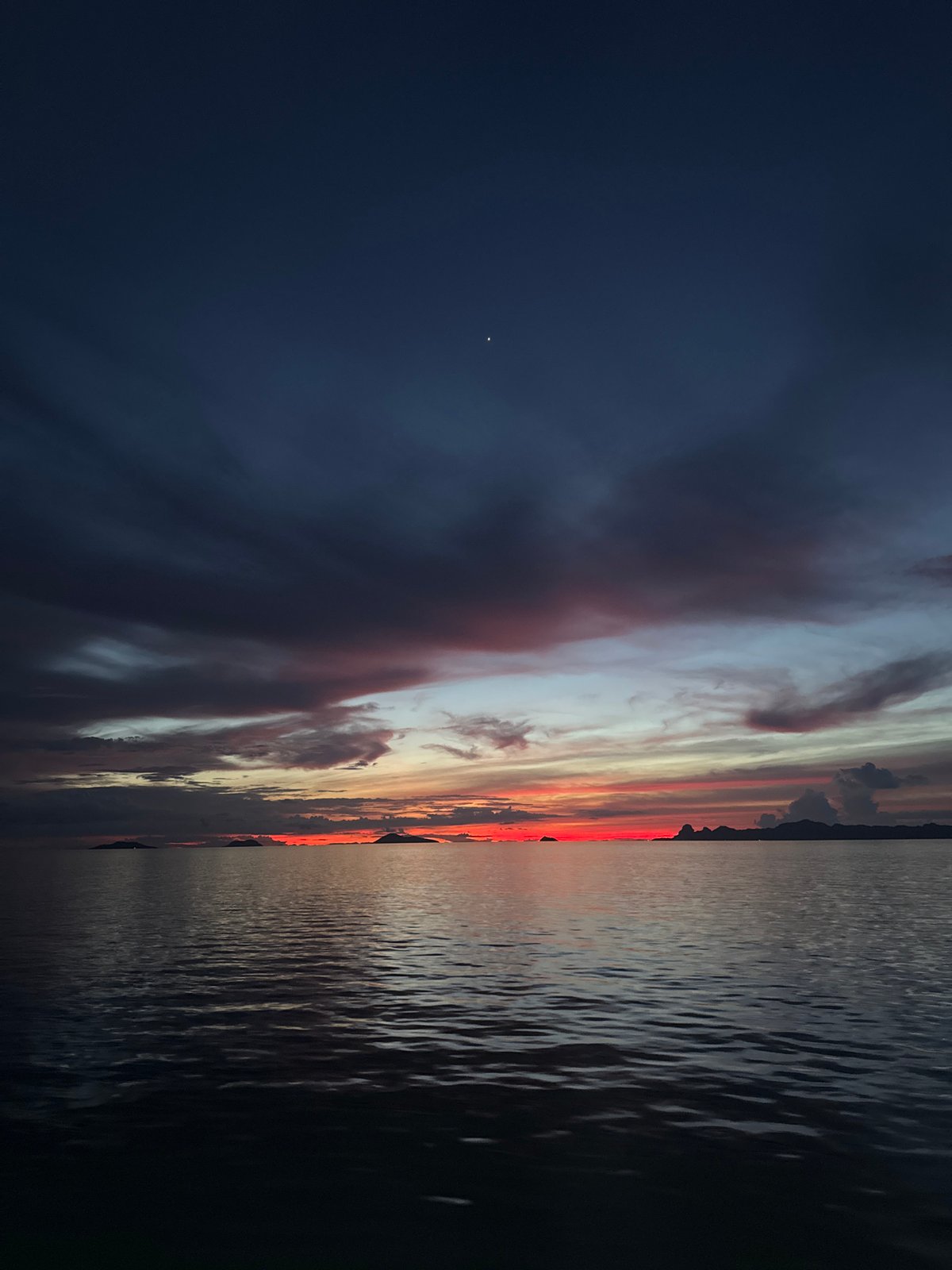 Andaman Sea twilight, sky bleeding from indigo to orange