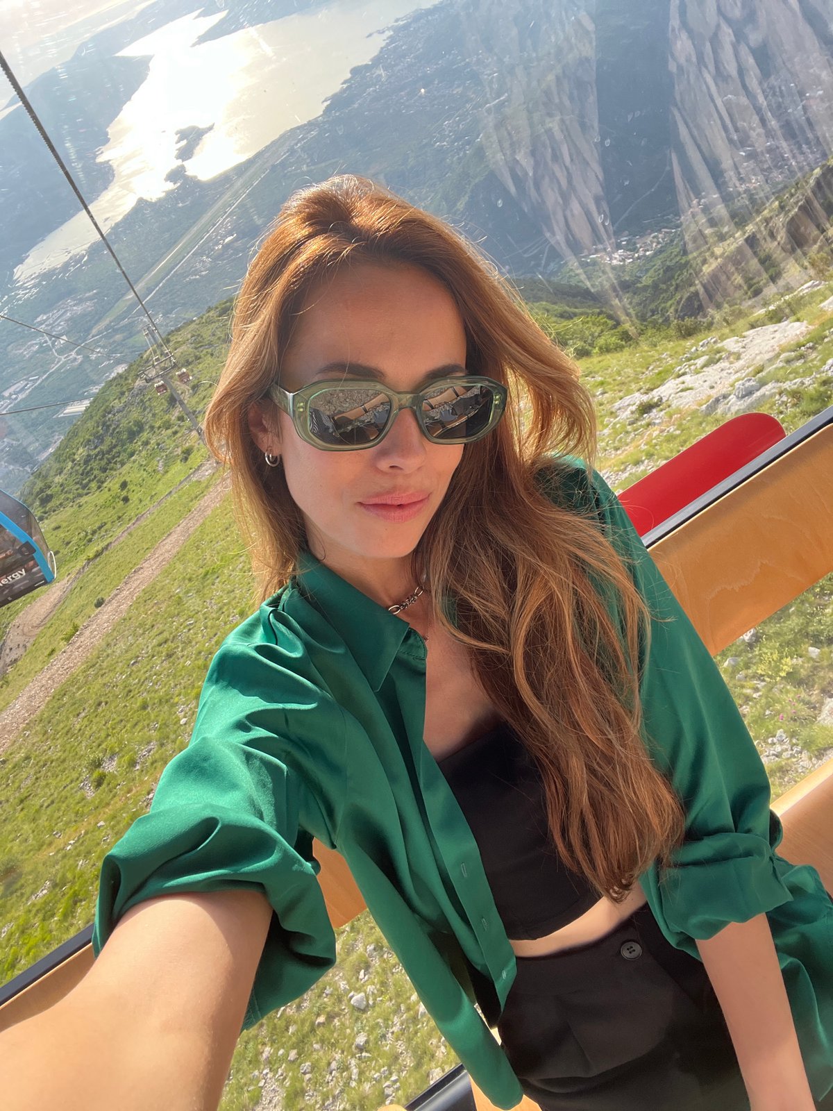 Woman takes selfie in cable car near Kuk, Montenegro
