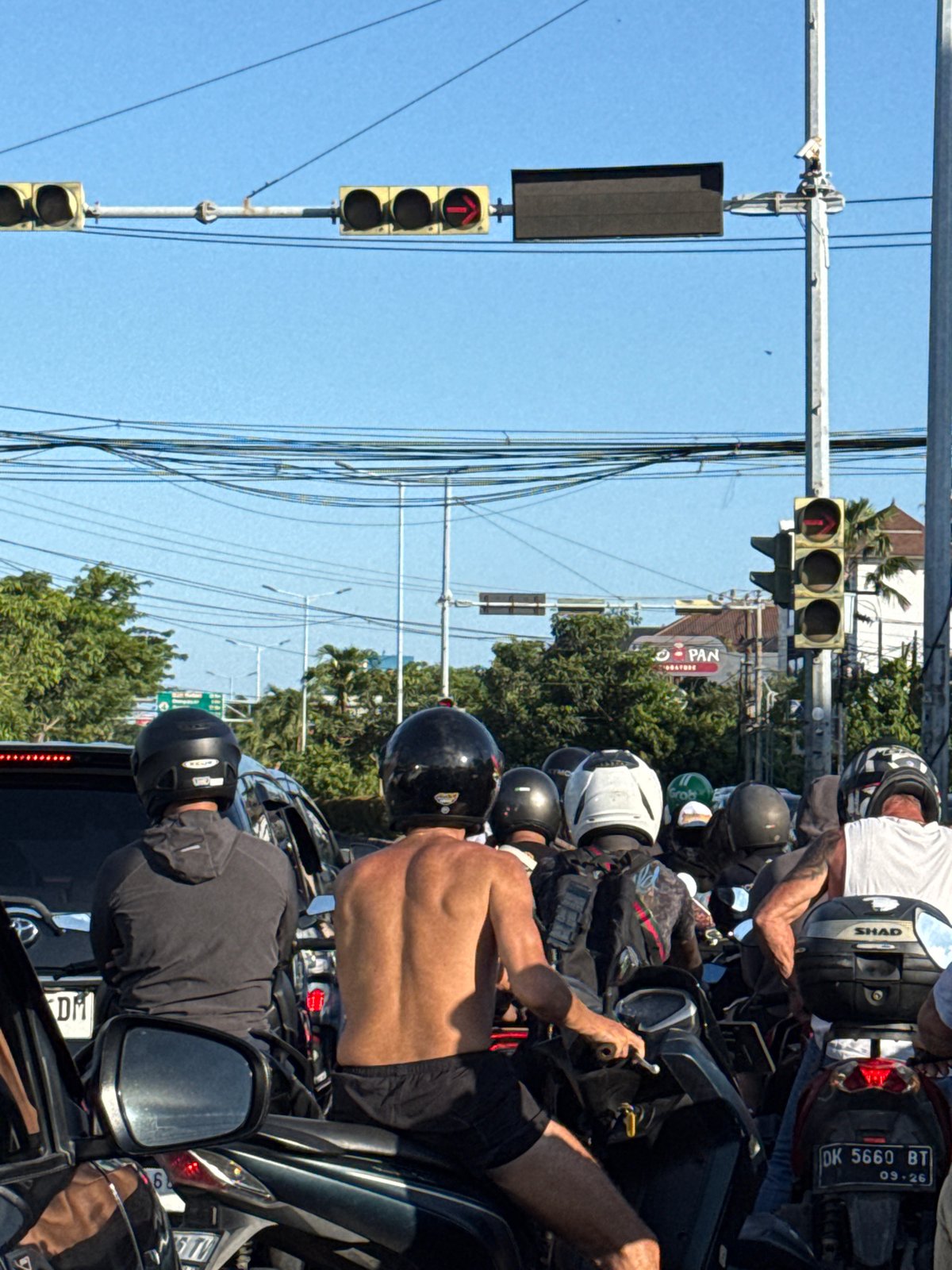 Motorcyclists stop at red light in Denpasar traffic