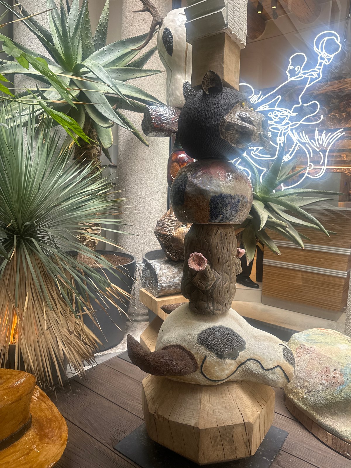 Art display with sculptures and plants spotted in Milan shop