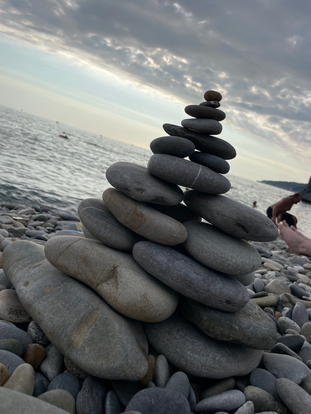 Stone stacking and stormy skies on the Sochi shoreline