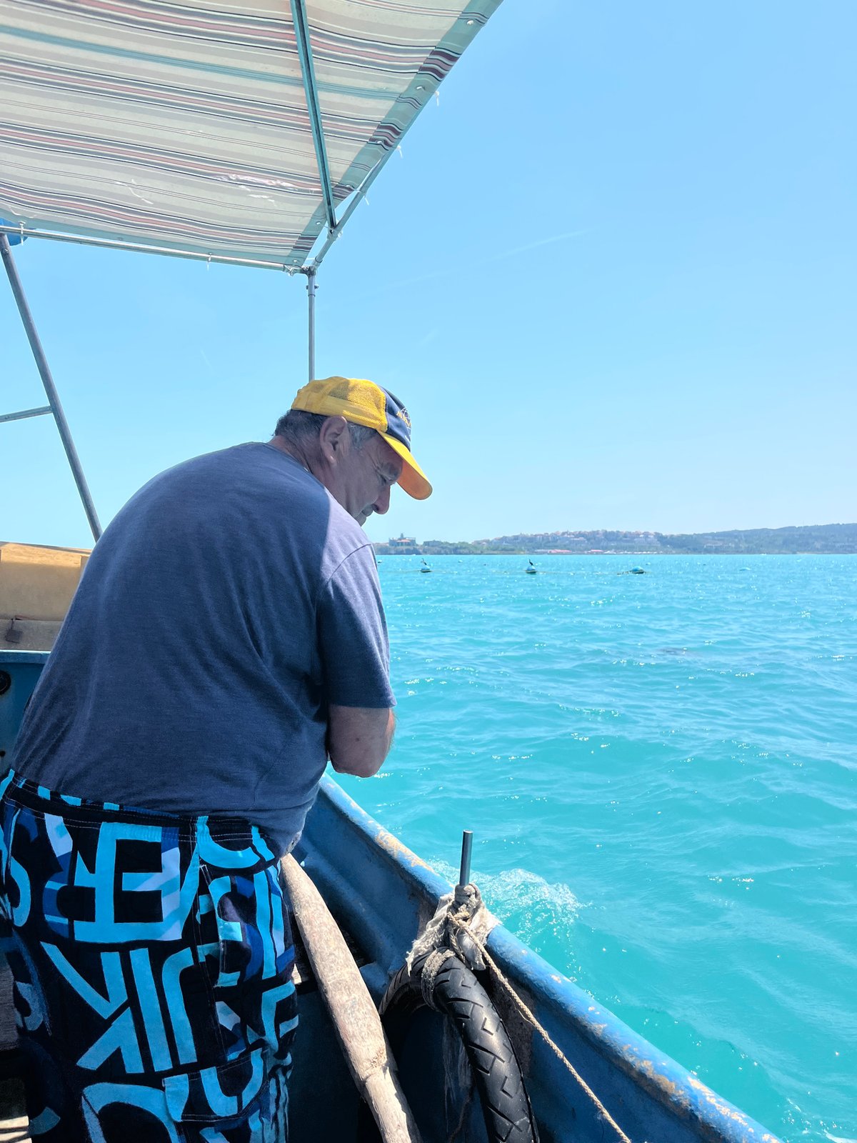 Fishing trip aboard blue boat on turquoise waters captured