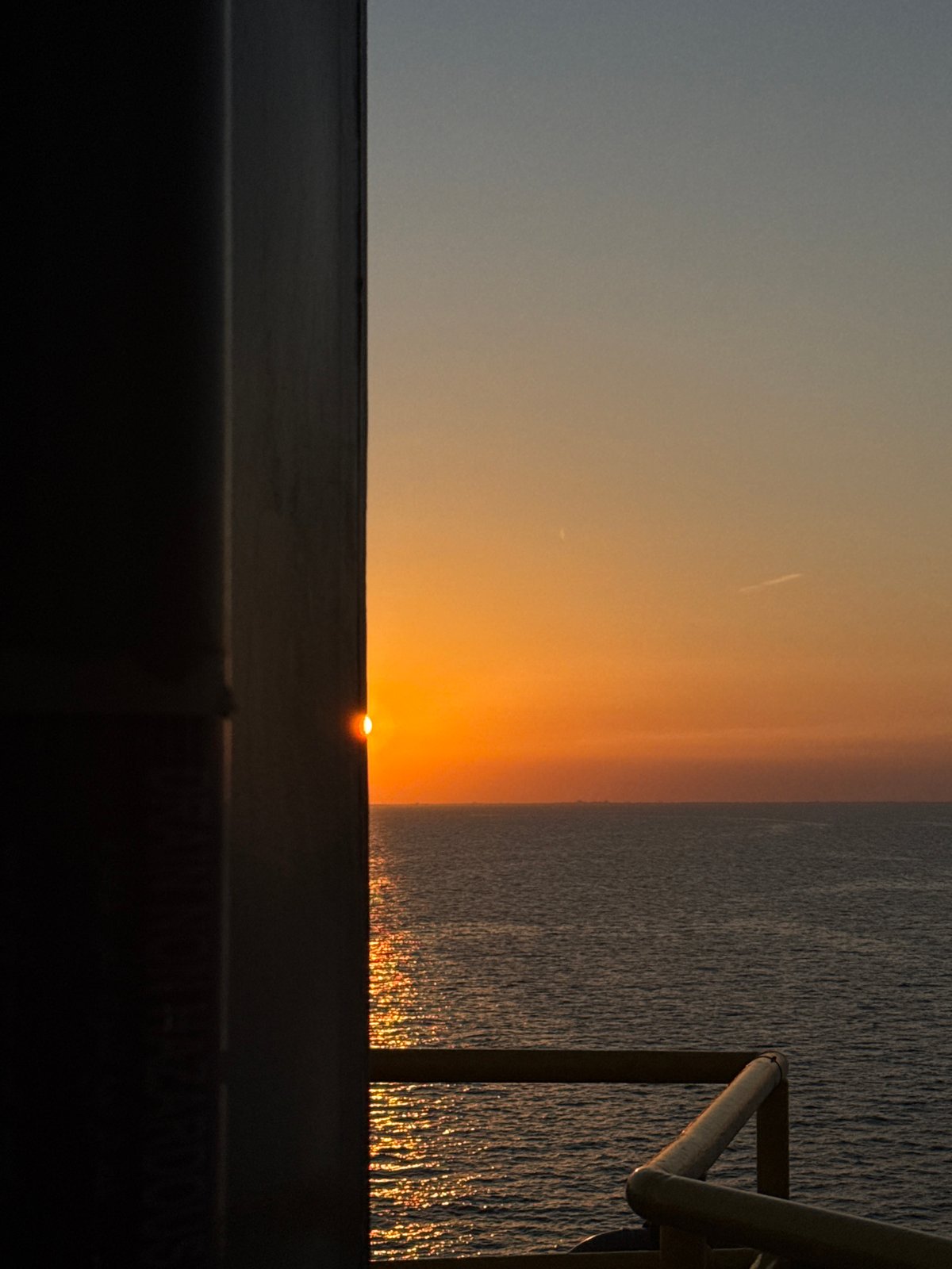 Sunset views from an active offshore oil rig, Italian waters