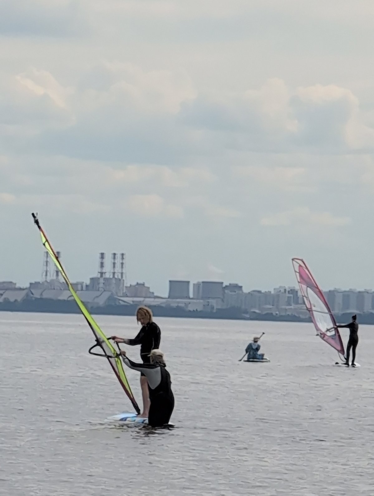 Windsurfing and paddleboarding on a calm Saint Petersburg waterway