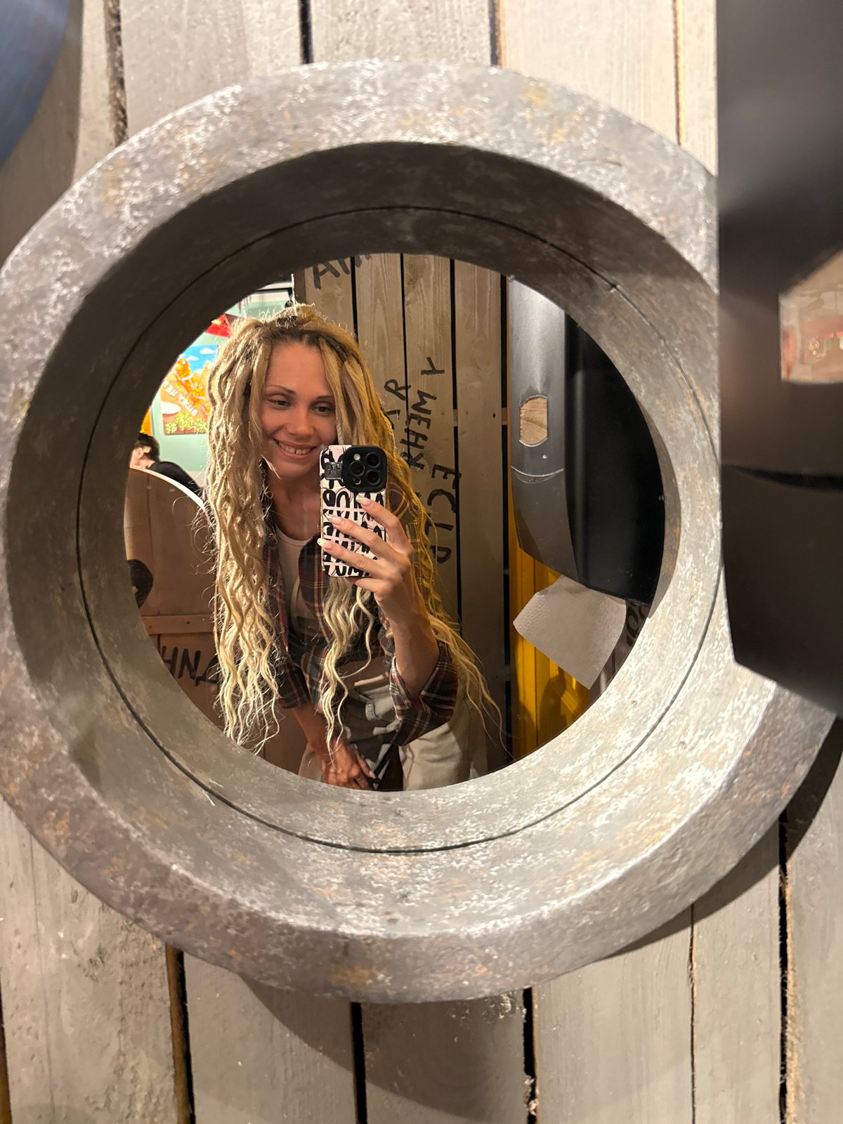 Woman takes mirror selfies in Zavolzhye restaurant