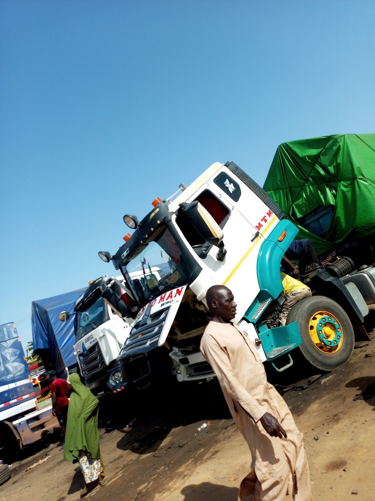 Trucks and market life in an African outdoor setting