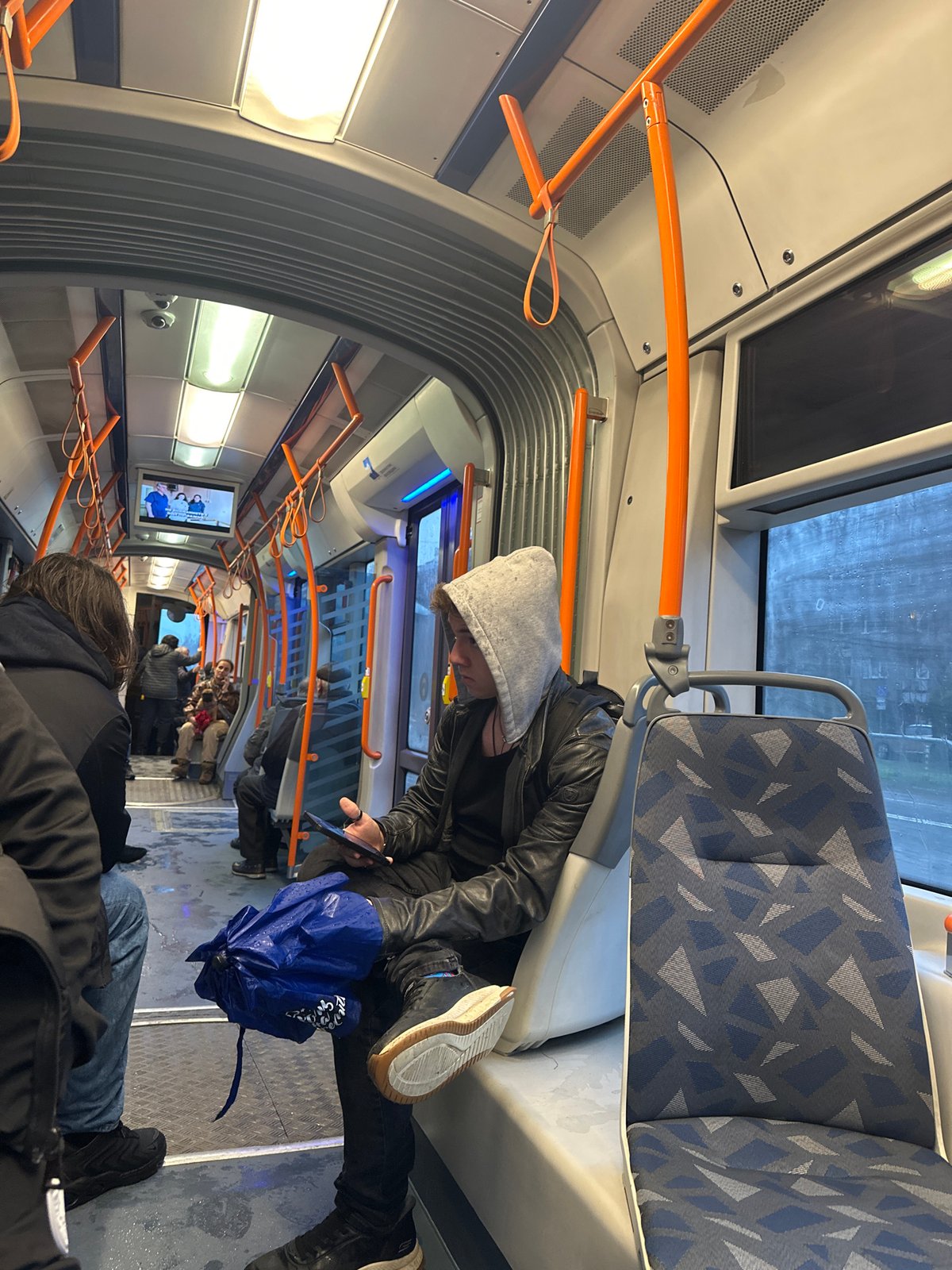 Person rests on public transport seats in Sofia