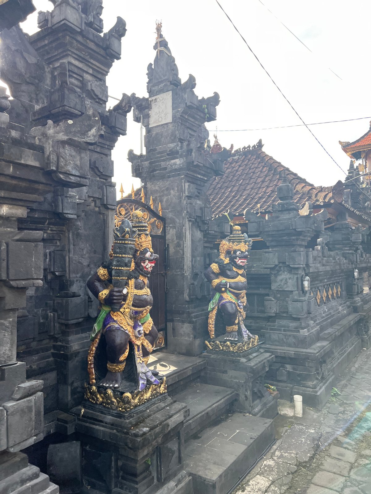 Balinese temple visit with guardian statues, North Kuta