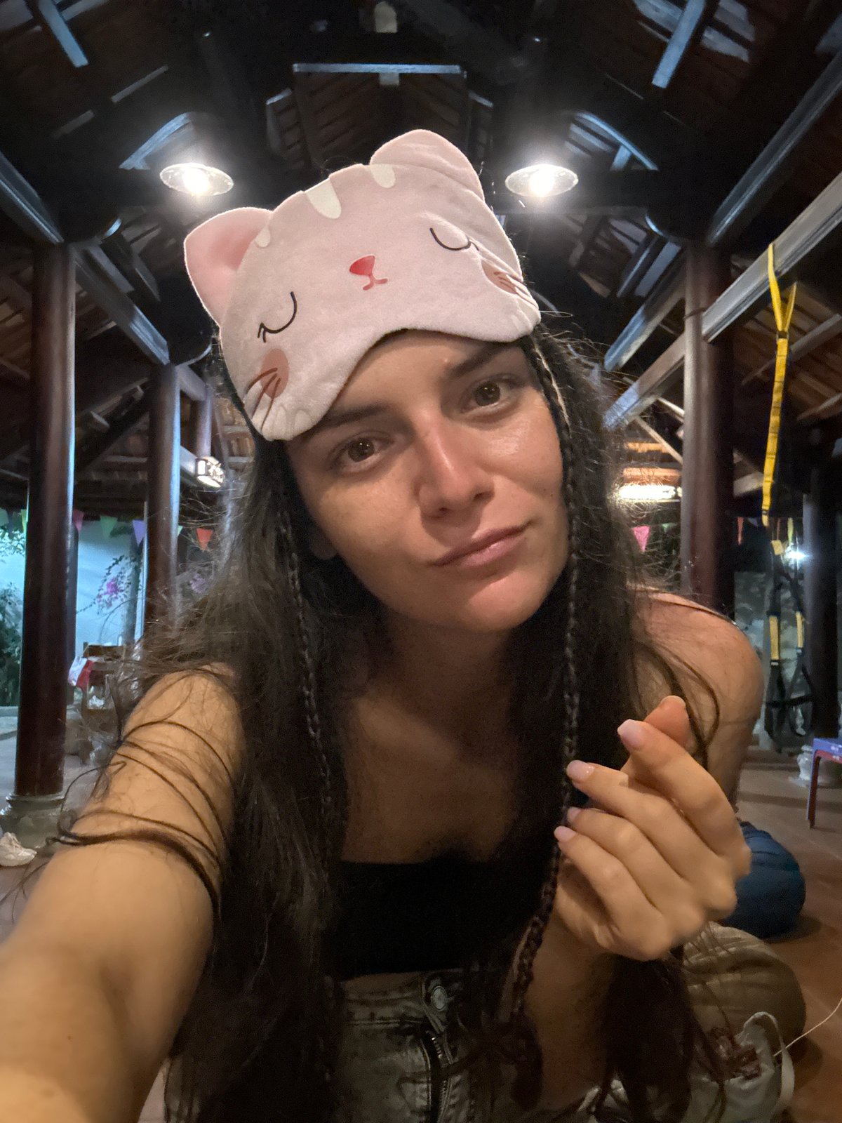 Woman photographed with pink cat mask in Mũi Né indoor space