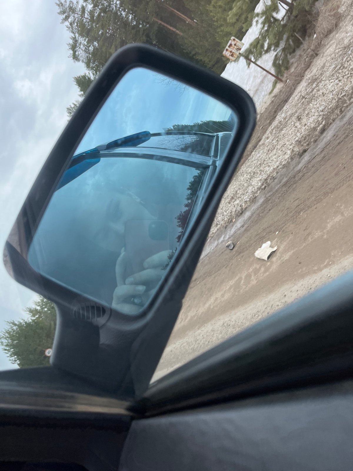 Driver captures phone selfie reflection in car mirror
