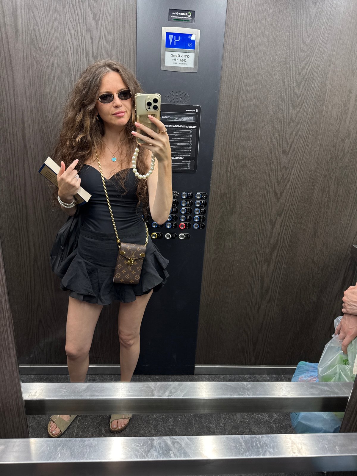 Elevator mirror selfie, accessorized and book in hand