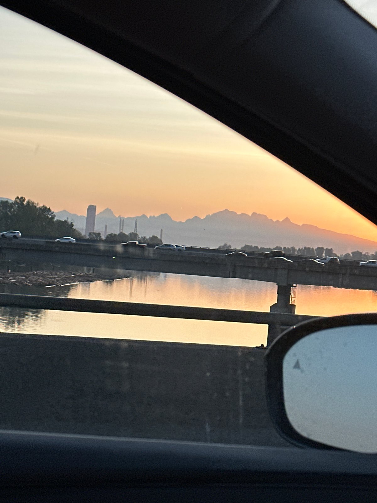 Golden sunset waterscape photographed from vehicle in Richmond