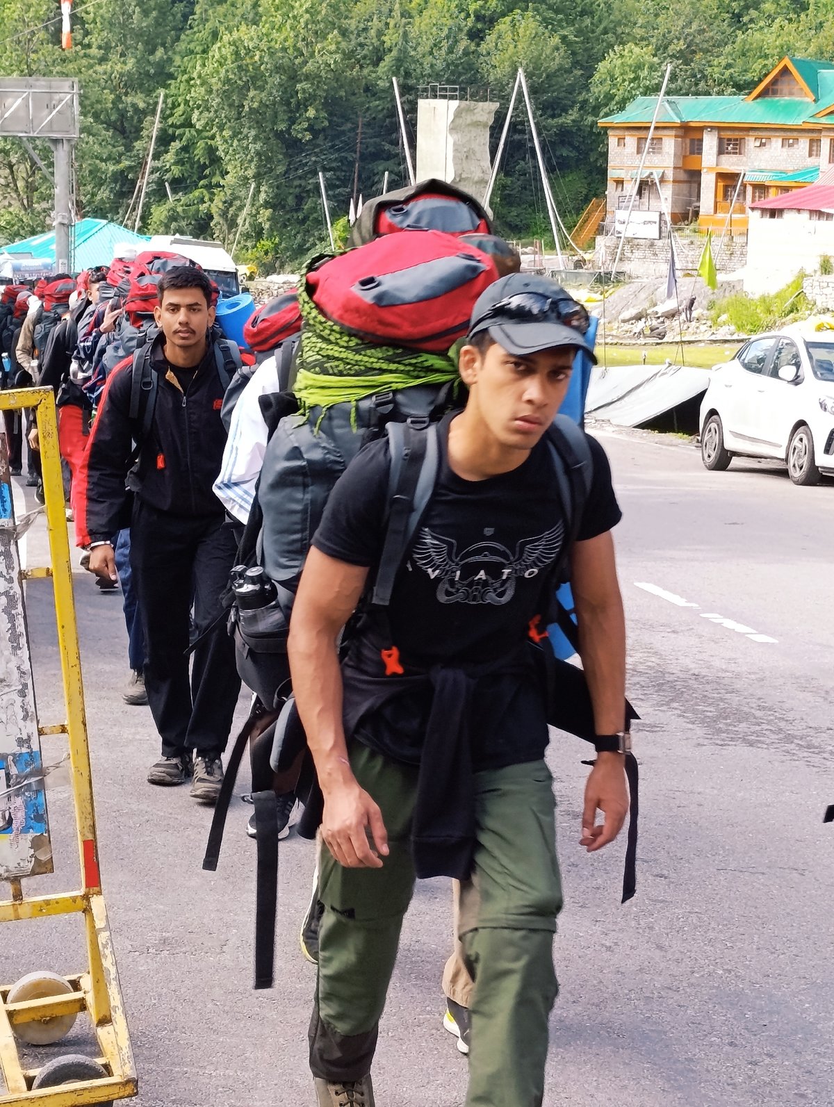 Trekking group heads out on paved road in Solang Valley