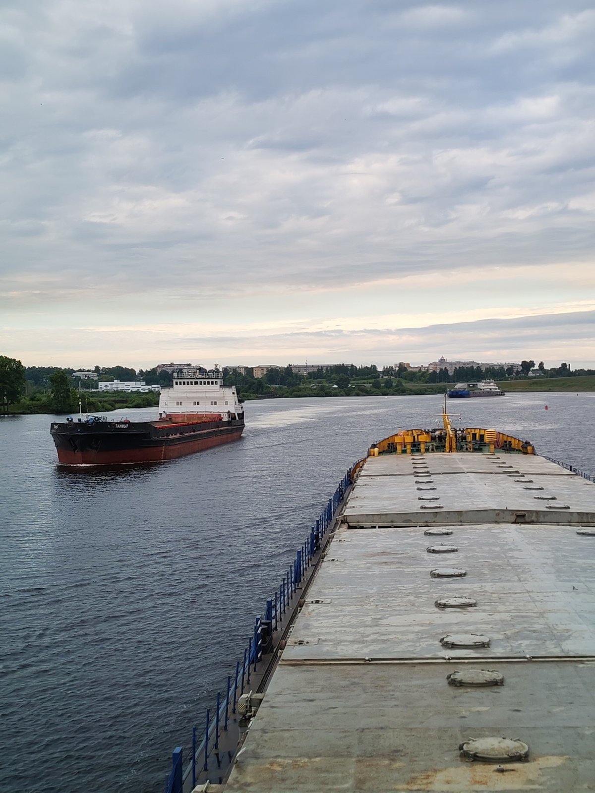 Russian cargo barges navigate a river lock system