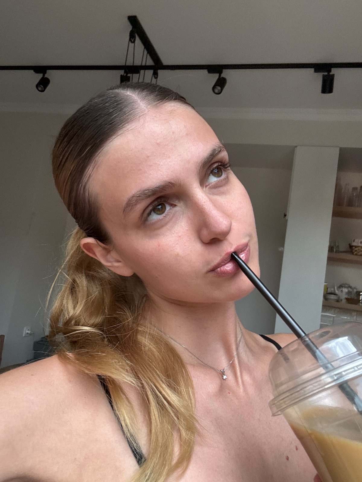 Woman enjoys indoor lunch break during rainy afternoon