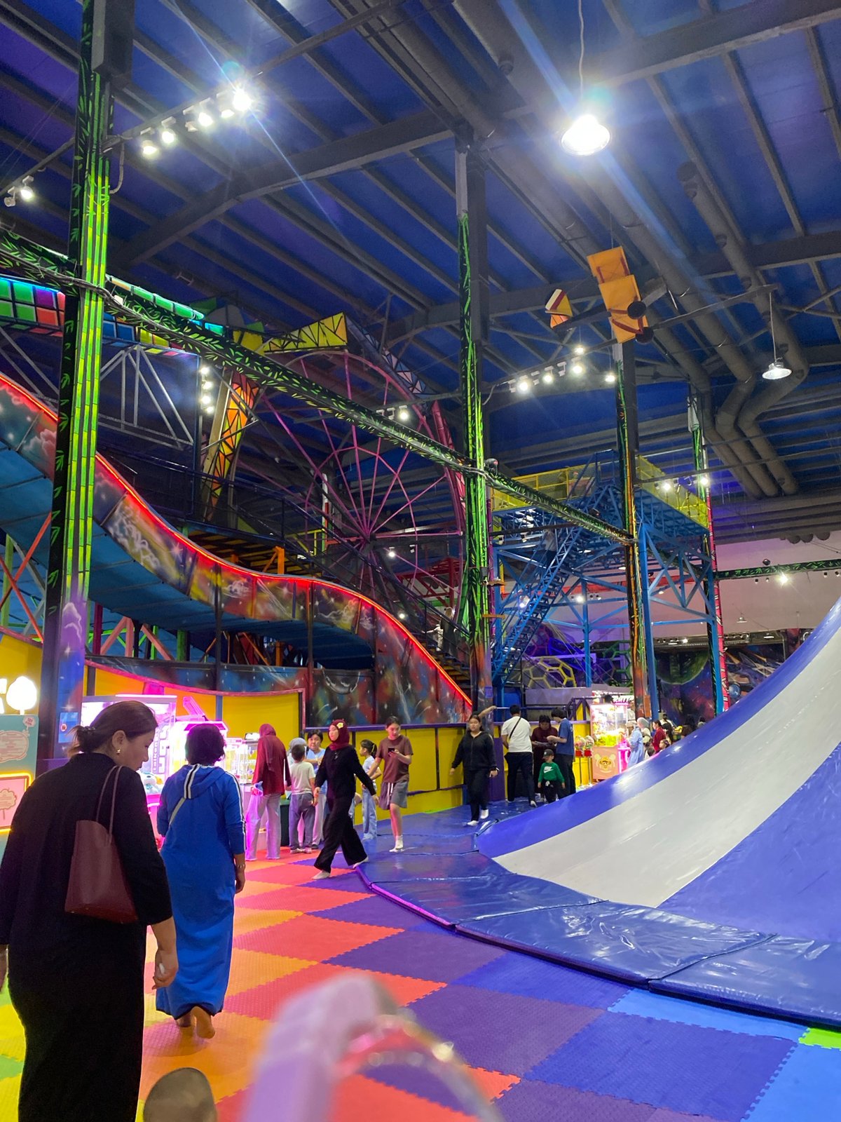 Inside a Bishkek indoor amusement park with rides and attractions