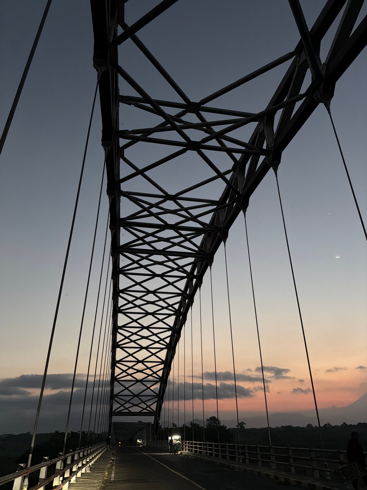 Suspension bridge at dusk, Selokanayar — steel and fading sky