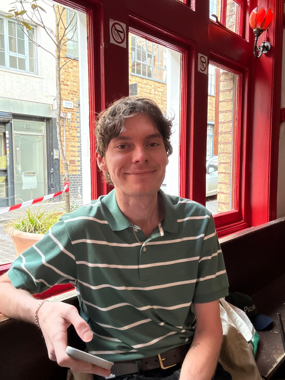 Man photographed smiling indoors in London