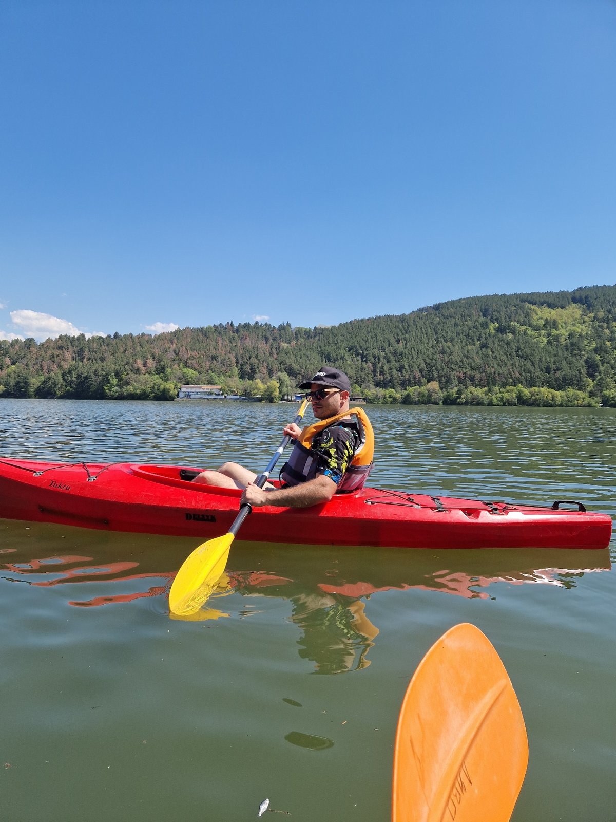 Two kayakers paddle on Pancharevo Lake, Bulgaria morning session