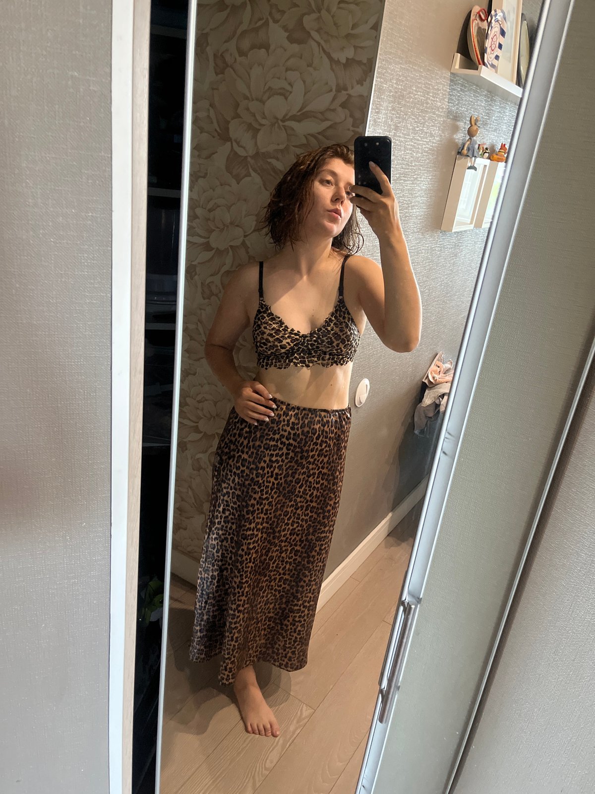 Woman takes leopard print outfit mirror selfie in Krasnoyarsk