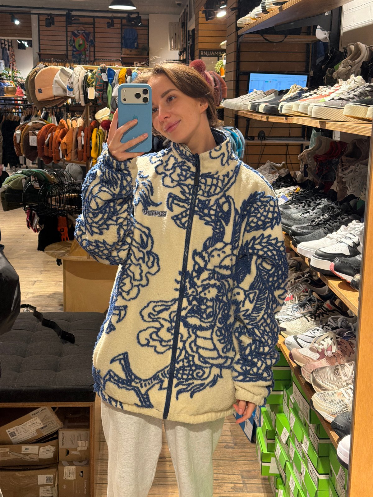 Woman takes mirror selfie at Moscow TRAWA store