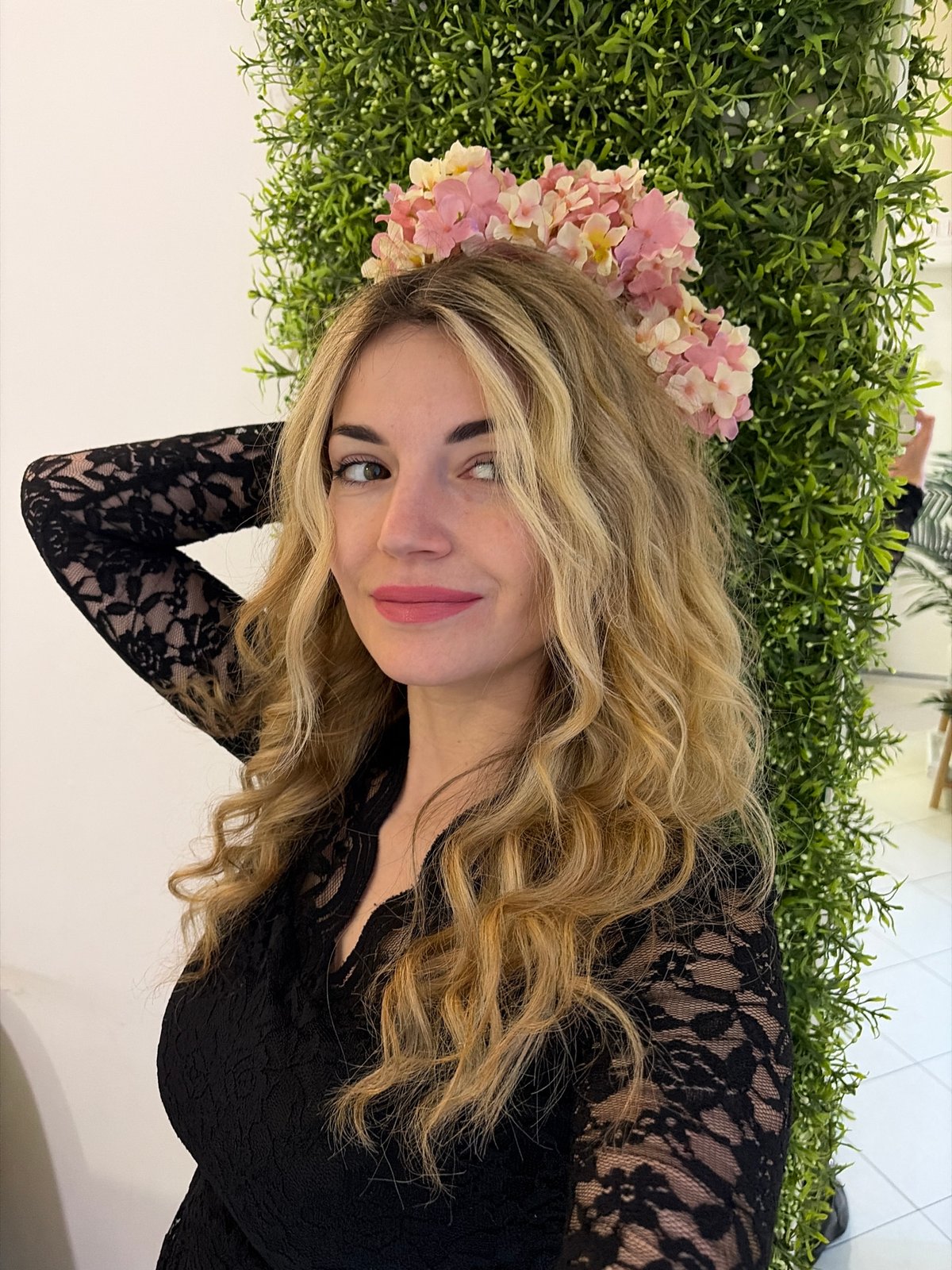Woman poses with gold heart balloons at Budva business