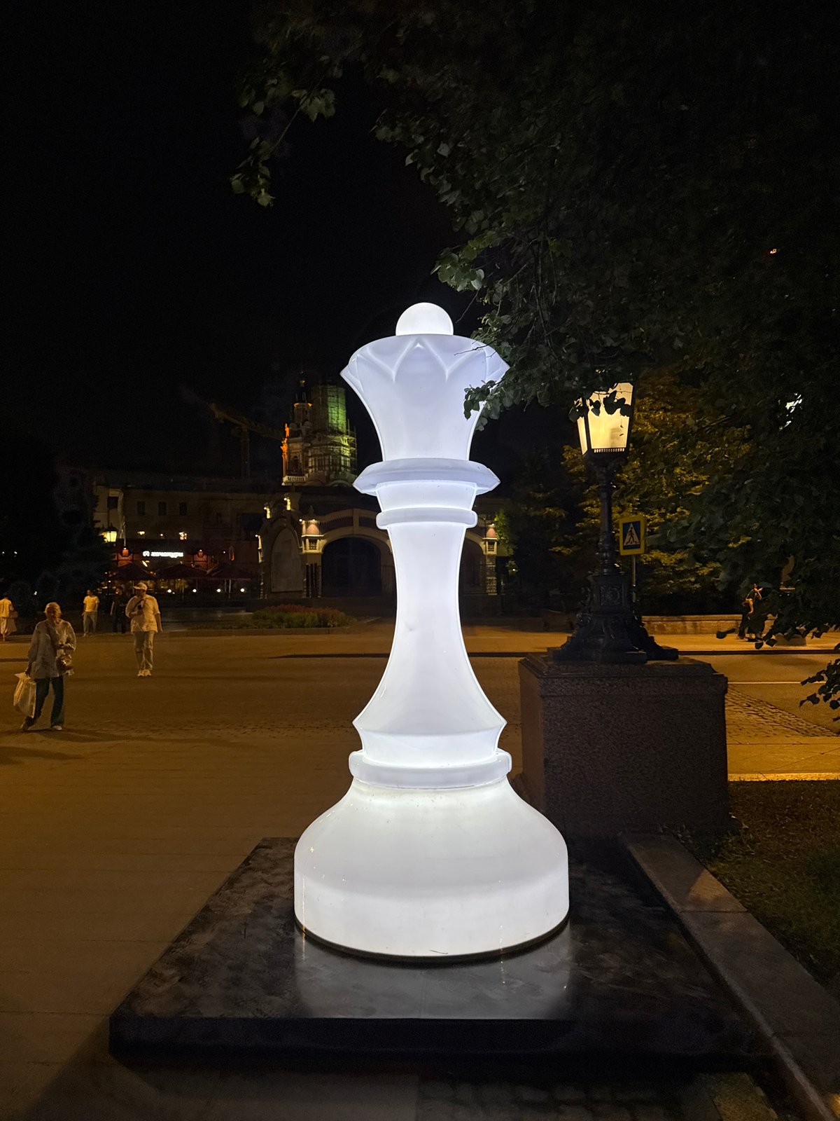 Chess-themed public art and a lit fountain in central Moscow